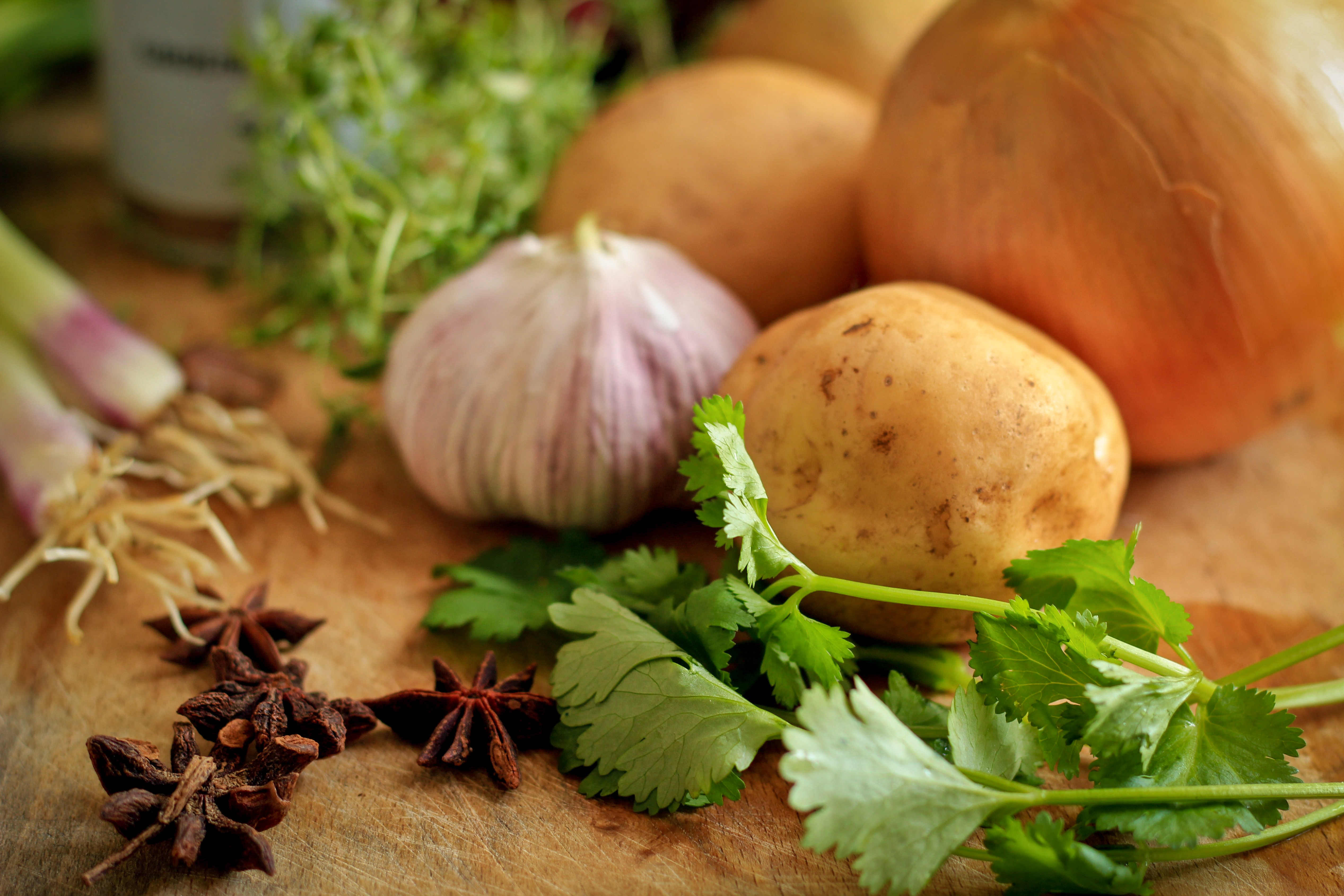 Garlic, potatoes, and herbs ready to be prepared for cooking